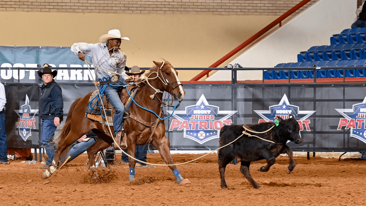 Jeffrey Hayes dismounts from mare "Lizzo" on his way to posting the fastest tie-down time of the day; a 7.76-second run.