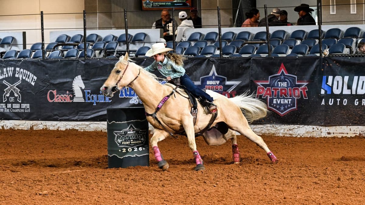 Barrel racer on palomino horse rounds a barrel at Fort Worth rodeo event in 2026