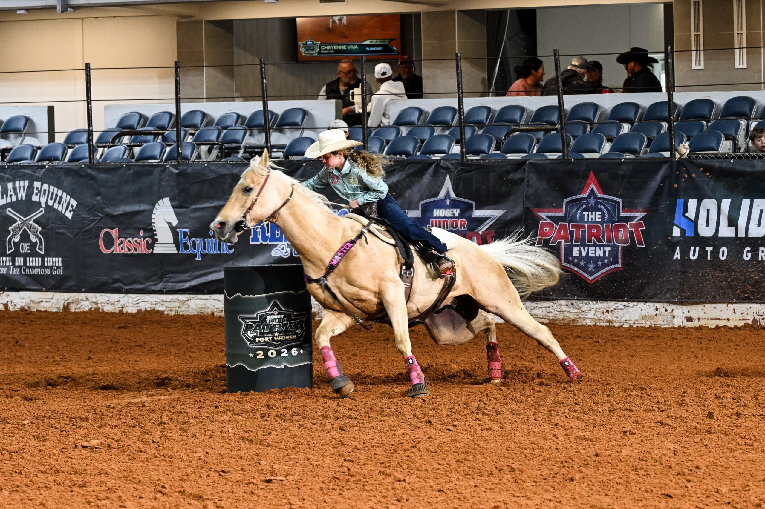 Barrel racer on palomino horse rounds a barrel at Fort Worth rodeo event in 2026