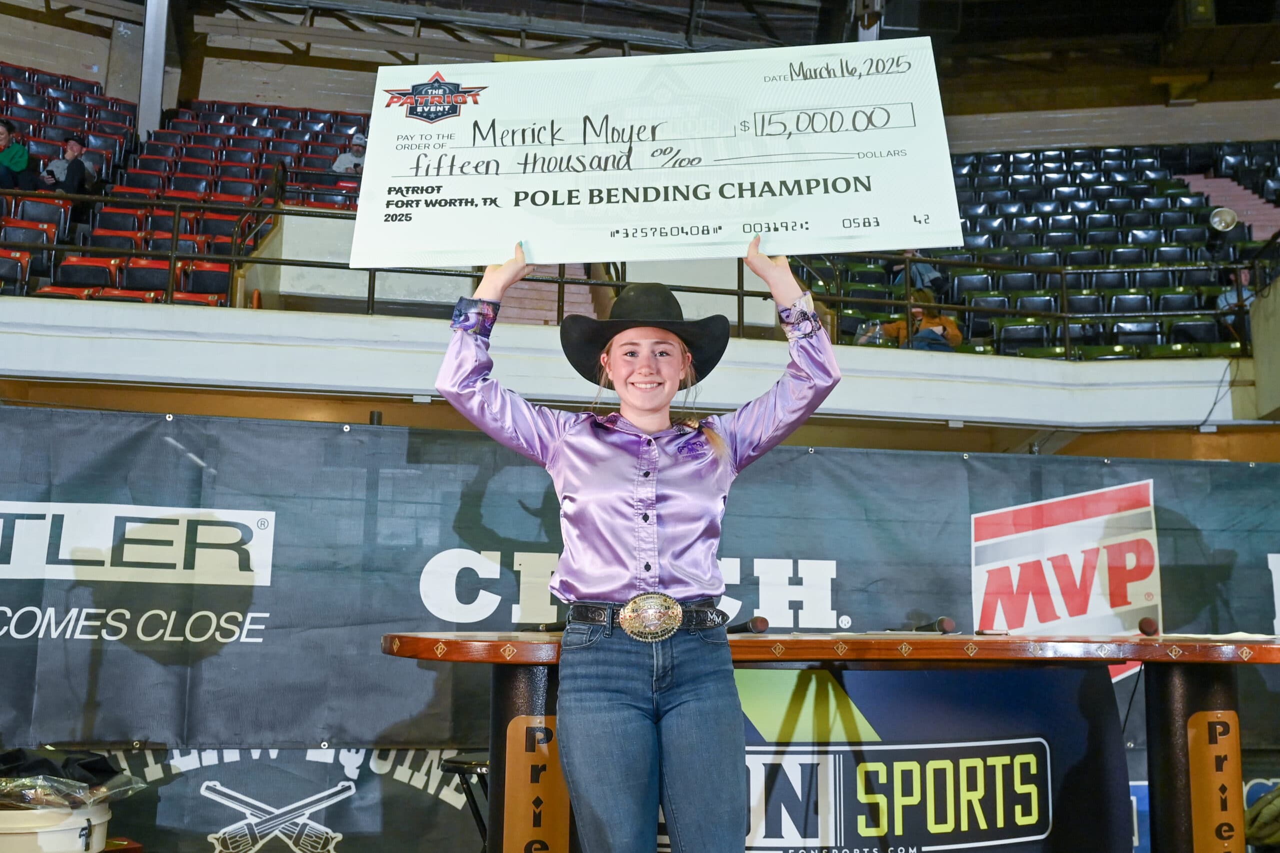 Merrick Moyer with her Hooey Jr. Patriot 19-&-Under Pole Bending check.