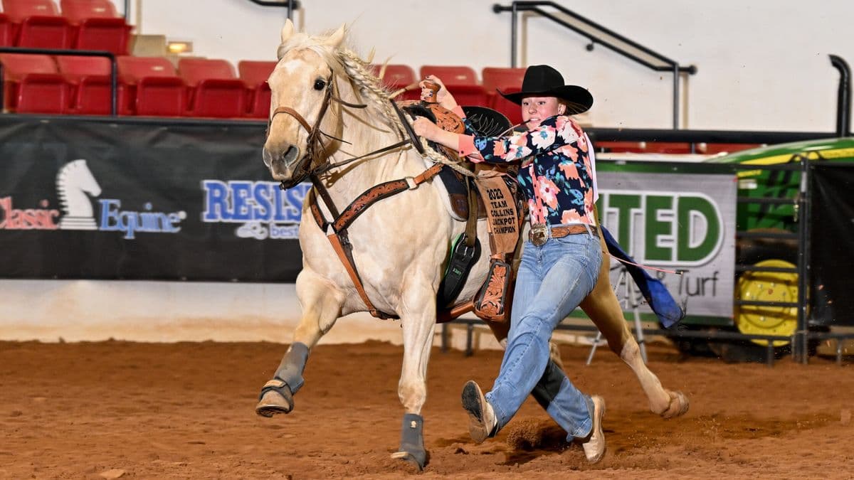 Sadie Patterson dismounts "Princess" on her way to a 6.16-second time in the 19-and-Under goat tying.