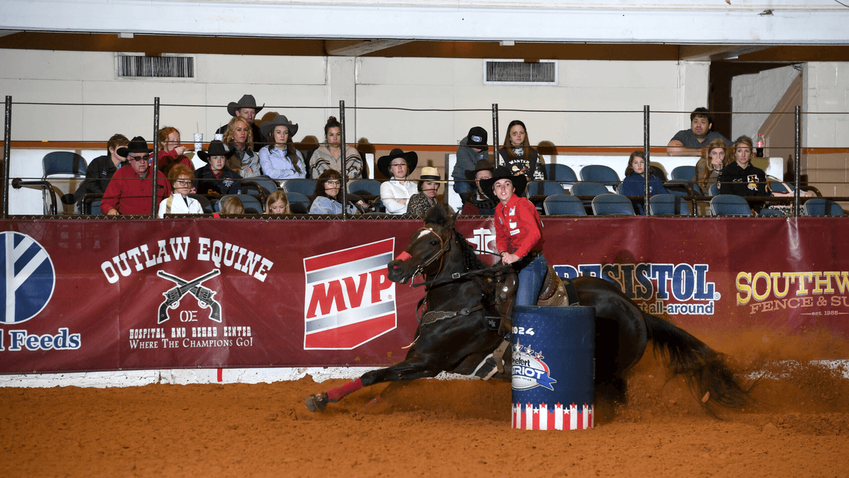 Tana Trosper turning Shiney Cartel around a barrel at the Hooey Junior Patriot.