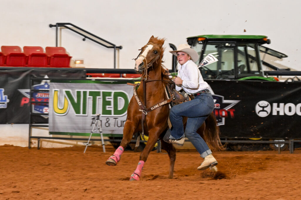 Ella Kay prepares to dismount "Lipstick" in the Hooey Jr. Patriot 15-and-Under Goat Tying Semifinals.