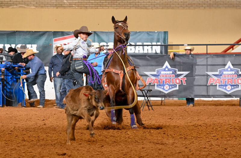 With a combined age of 15, 10-year-old Jackson Ashton and 5-year-old "Moto" won the Hooey Jr. Patriot 12-and-Under Tie-Down Jackpot Championship.